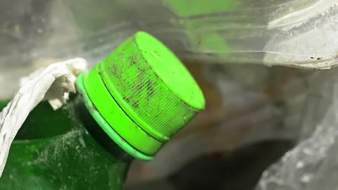 Close-up of dirty plastic bottle garbage being recycled Stock Footage 332649617