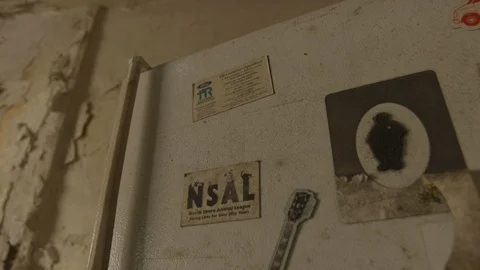 Close up of dirty refrigerator left inside abandoned rundown house in Stock Footage 114736570