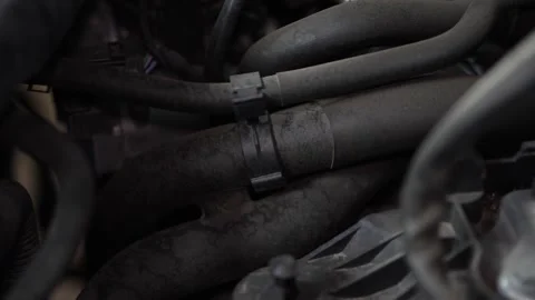 Close-up of dirty rubber coolant hoses inside car engine bay. Stock Footage 345709182