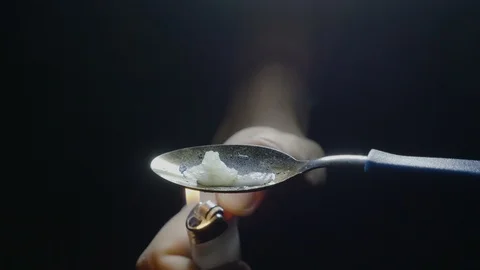Close up of a dirty spoon in a dark room in which is put solid drugs to be he Stock Footage 86880131