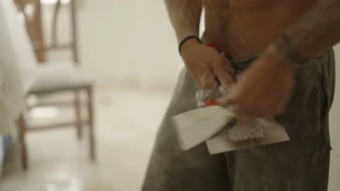 Close up of dirty unrecognizable man using spatula in home improvement process Video stock 209602337