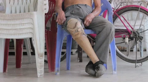 Close-up disable old man with prosthesis sitting on the chair Stock Footage 64836968