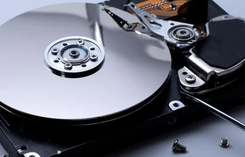 Close up of a Disassembled computer hard drive on white isolated background w Stock Photos