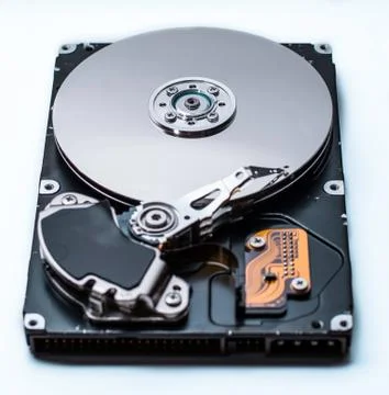 Close up of a Disassembled computer hard drive on white isolated background w Stock Photos