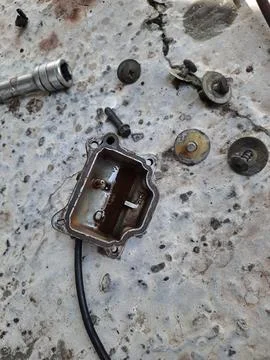 Close-Up of a Disassembled Small Engine Part on a Weathered Surface Stock Photos