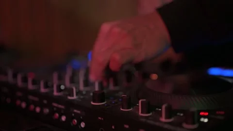 Close up of a disc jockey's hands manipulating faders and knobs on a sound Stock-Footage 327684508