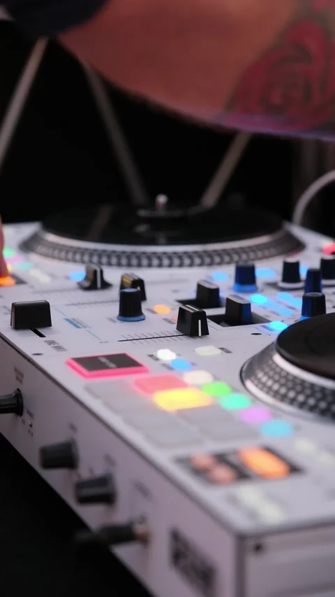 Close-up of a disc jockey's hands manipulating a sound mixer, adjusting faders Stock Footage 344007437