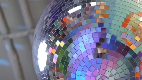 Close-up disco ball hanging on the ceiling. Mirrored sphere reflecting modern Stock Footage 311663531