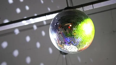 Close-up disco ball hanging on the ceiling. Mirrored sphere reflecting modern Stock Footage 311663900