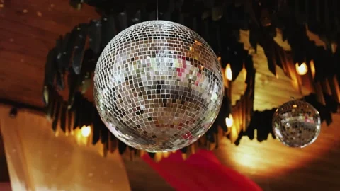 Close-up of a disco ball hanging from the ceiling and emitting light, suitable Stock Footage 324676877