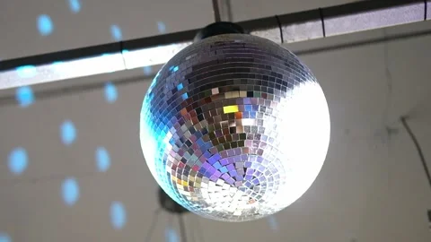 Close-up disco ball hanging on the ceiling. Mirrored sphere reflecting modern Vidéo 346720252