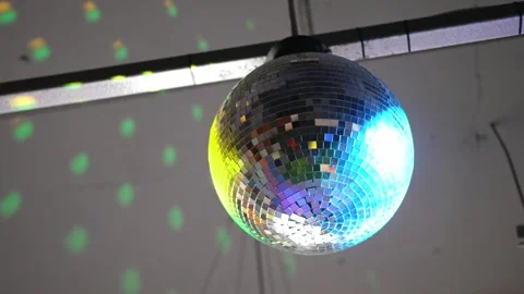 Close-up disco ball hanging on the ceiling. Mirrored sphere reflecting modern Vídeos de archivo 346720264