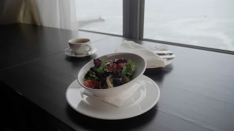 Close-up of a dish of baked eggplant with tomatoes on the table by the window Stock Footage 155258169