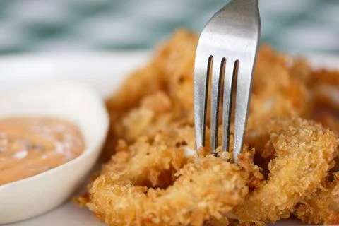 Close-up dish of fried squid ring with fork Stock Photos