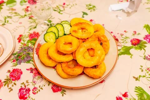 Close-up dish of fried squid ring with fresh cucumbers. Vegetarian food Stock Photos