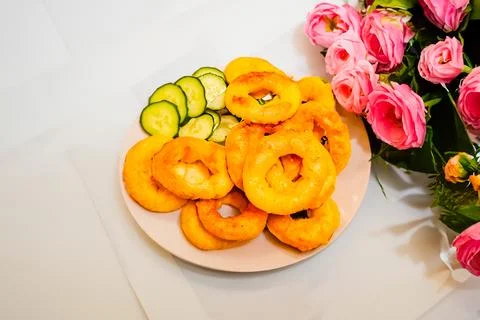 Close-up dish of fried squid ring with fresh cucumbers. Vegetarian food Stock Photos