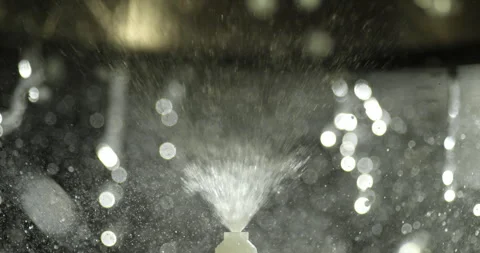 Close up of a dish washer sprayer nozzle spraying water upwards into a pot Stock Footage 310528174