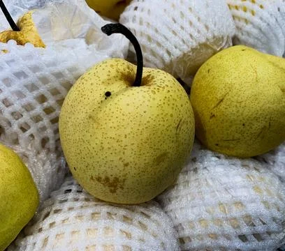 Close-Up Display of Various Types of Fresh Pears in a Supermarket Fruit Displ Stock Photos