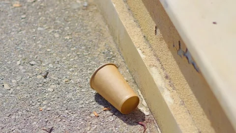 Close-up of a disposable cup lying on the ground in 4k slow motion 60fps Video stock 284218907