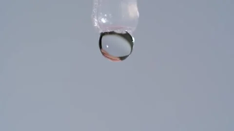 Close-up: Disposable eye drop vial administering solution into an open eye. Stock Footage 320826103