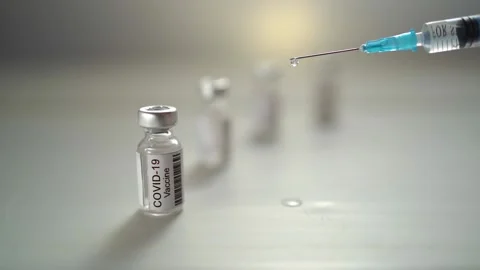 Close-up disposable syringe with a drop of liquid medicine on the needle Stock Footage 158984357