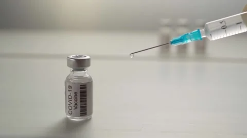 Close-up disposable syringe with a drop of liquid medicine Stock Footage 158993842