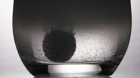 Close up of dissolving tablet in glass of water Stock Footage 57483816