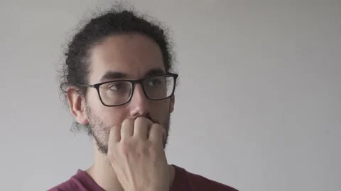 Close up of distracted young man biting his nails Stock Footage 161552157