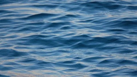 Close up of disturbed blue ocean water surface. Slow motion Stock Footage