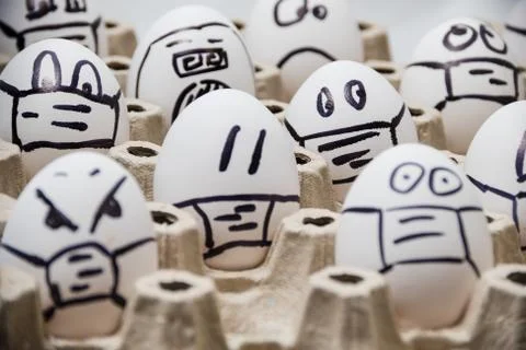 Close up of diverse chicken easter eggs with doodle emotional faces wearing Stock Photos