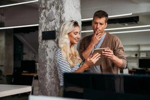 Close up diverse colleagues using tablet together, discussing online project Foto stock