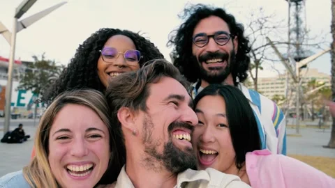 Close up of a diverse group of friends smiling and taking a selfie in the street Stock Footage 247967003