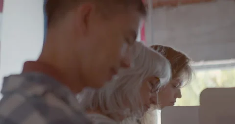 Close up on a diverse group of voters at a polling station voting Stock Footage 274958751