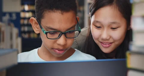 Close up of diverse school students studying and reading together in library. Stock Footage 151404544