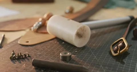 Close up of diverse tools lying on table in leather workshop Stock Footage 344643501