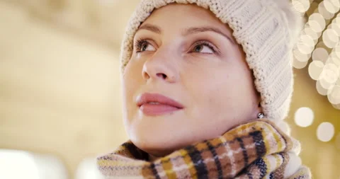Close up divinely inspired face of young girl in hat and scarf thinking about Video stock 166053104