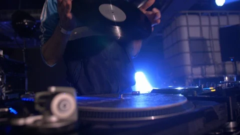 CLOSE UP OF DJ FLIPPING VINYL, PLAYING AND MIXING WITH HAND IN THE CLUB Stock Footage 128356679
