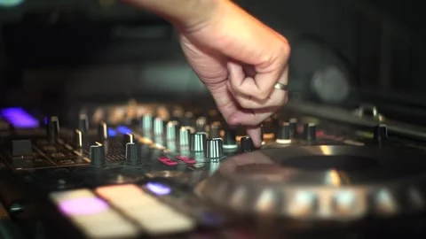 Close-up of DJ hands adjusting knobs and sliders on a professional mixer Stock Footage 319613528