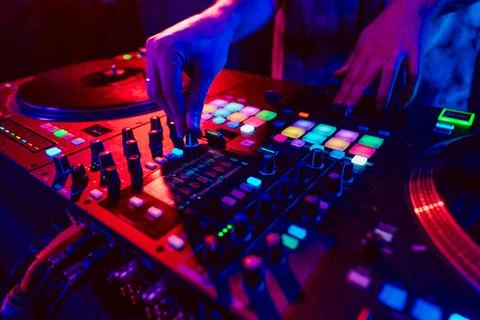 Close up of DJ hands on dj console mixer during concert in the club Stock Photos