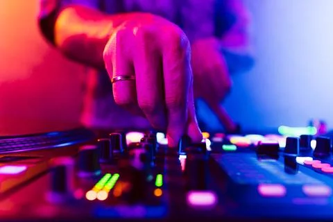 Close up of DJ hands on dj console mixer during concert in the club Stock Photos