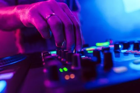 Close up of DJ hands on dj console mixer during concert in the club Stock Photos