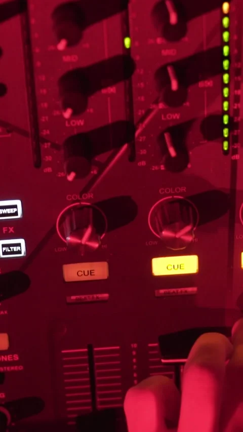 Close Up of DJ Mixer Controls and Audio Console Under Red Club Lighting Stock Footage 337902700