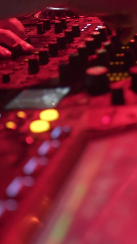 Close-Up of DJ Mixing Music on Controller at Nightclub Event Stock Footage 337902812