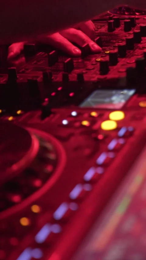 Close-Up of DJ Mixing Music on Controller at Nightclub Event Stock Footage 337902813