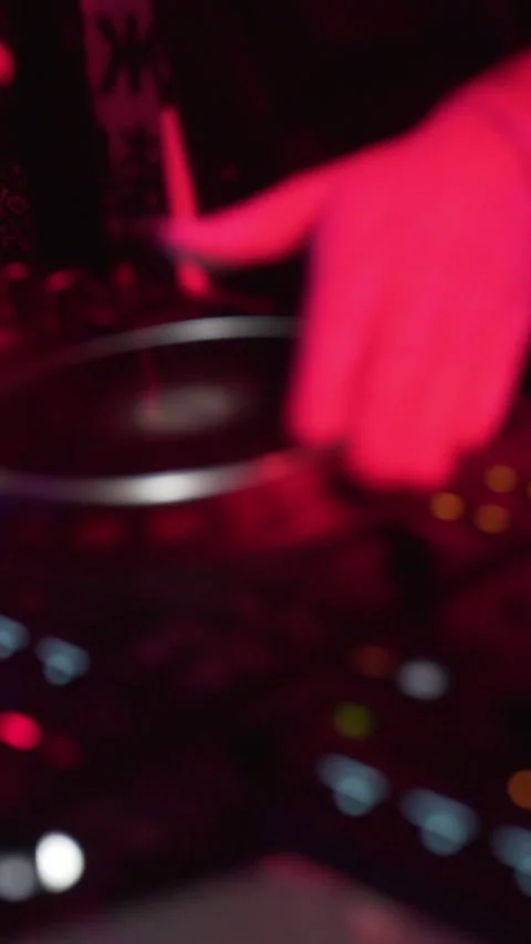 Close-Up of DJ Mixing Music on Controller at Nightclub Event Stock Footage 337902838