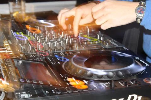 Close up of a DJ playing with CDJs and a mixer Stock Photos