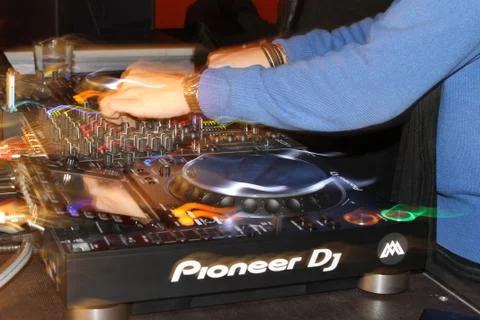 Close up of a DJ playing with CDJs and a mixer Stock Photos