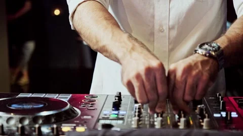 Close up DJ plays live set and mixing music on turntable console in the club Stock Footage 301439532