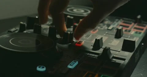 Close up of DJ turning adjusting knobs on small DJ controller Video stock 233313487
