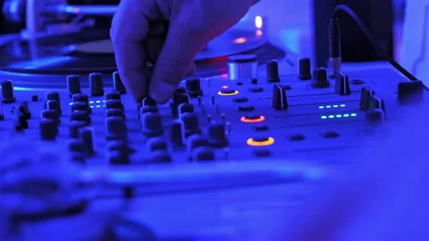 Close-Up of DJ Tweaking Mixer Knobs During a Live Club Performance, Party - 4K Video stock 303836967
